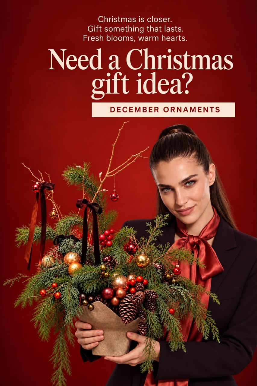 Festive Christmas gifting poster — a woman in a dark blazer with a red satin bow holding a decorated evergreen arrangement, with the words Need a Christmas gift idea? December ornaments
