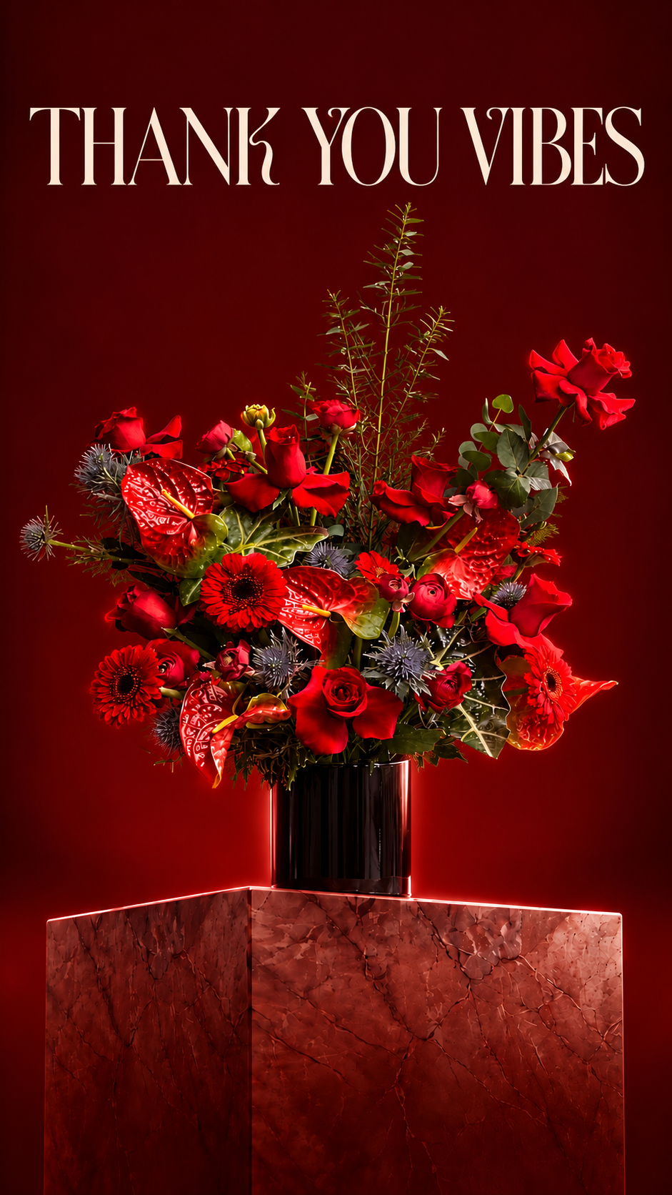 Red roses and anthuriums in a black vase on a red marble pedestal, with THANK YOU VIBES above